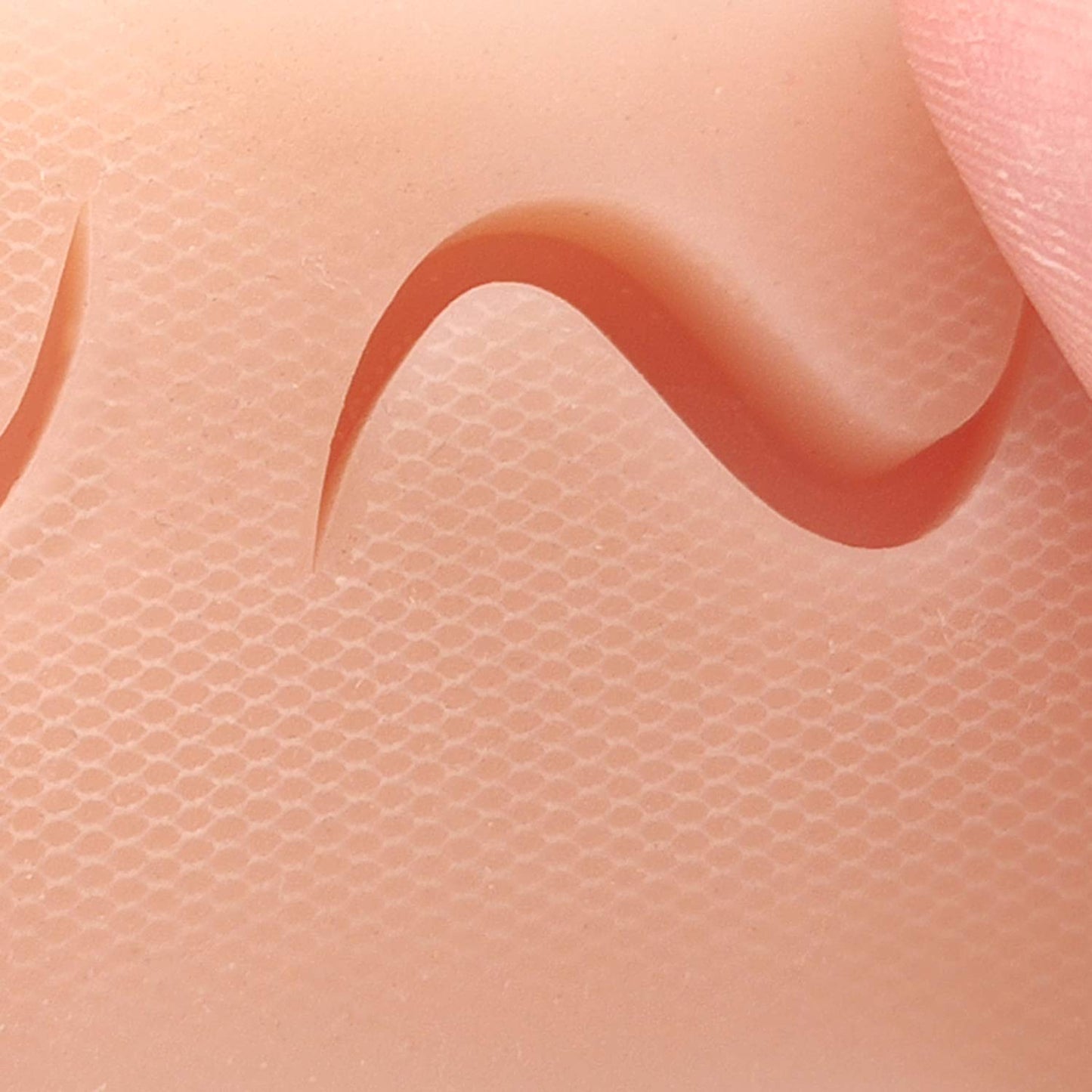 Suture Pad with Mesh-Reinforced Skin Layer for Durability